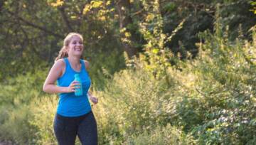 Młoda kobieta ciesząca się zdrowym stylem życia podczas joggingu