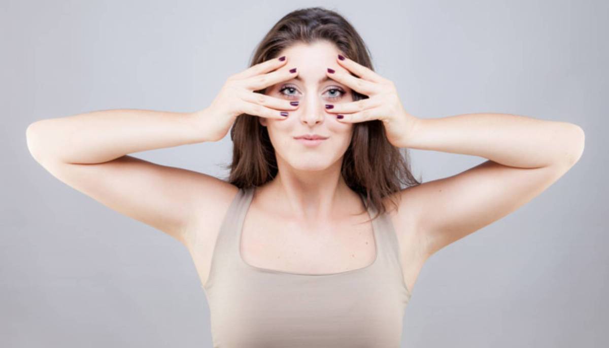 Beautiful young caucasian woman doing face yoga pose