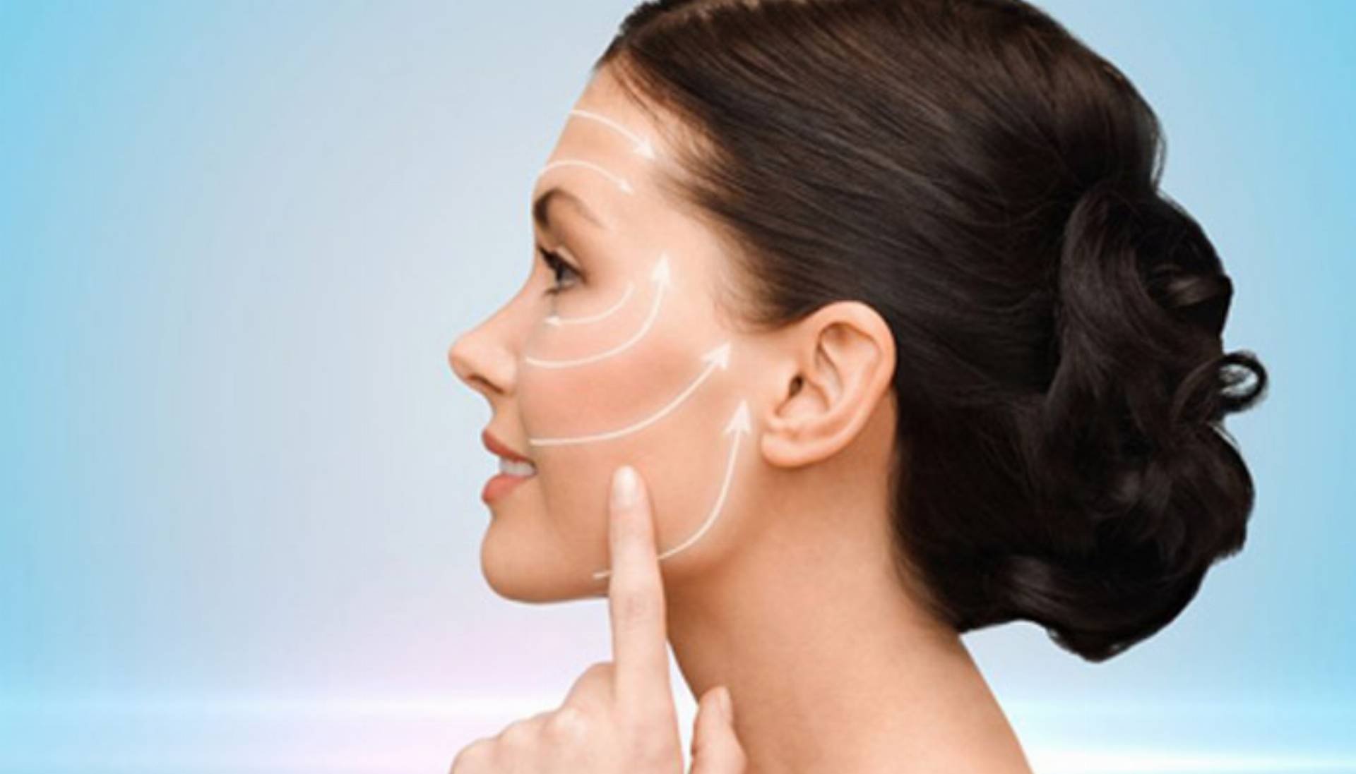 beauty, spa and health concept - smiling young woman pointing to her cheek