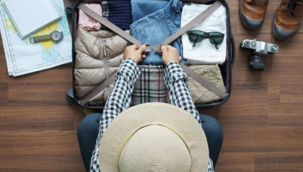 Widok z góry człowieka pakującego bagaż w domu