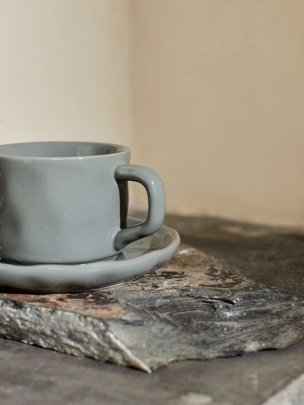 szara filiżanka ze spodeczkiem