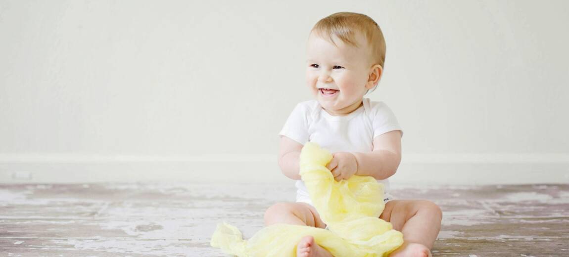 maluch-siedzi i uśmiecha się