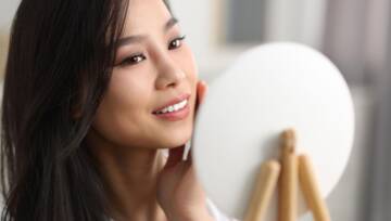 Atrakcyjna Koreanka prezentująca gładką cerę po zastosowaniu karnozyny w kosmetykach
